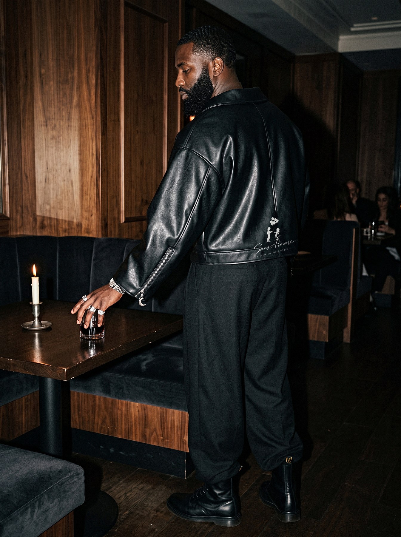 A man from behind in the jacket, the boy and girl graphic on its back